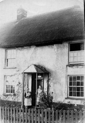 Pitts couple at door of Morchard cottage